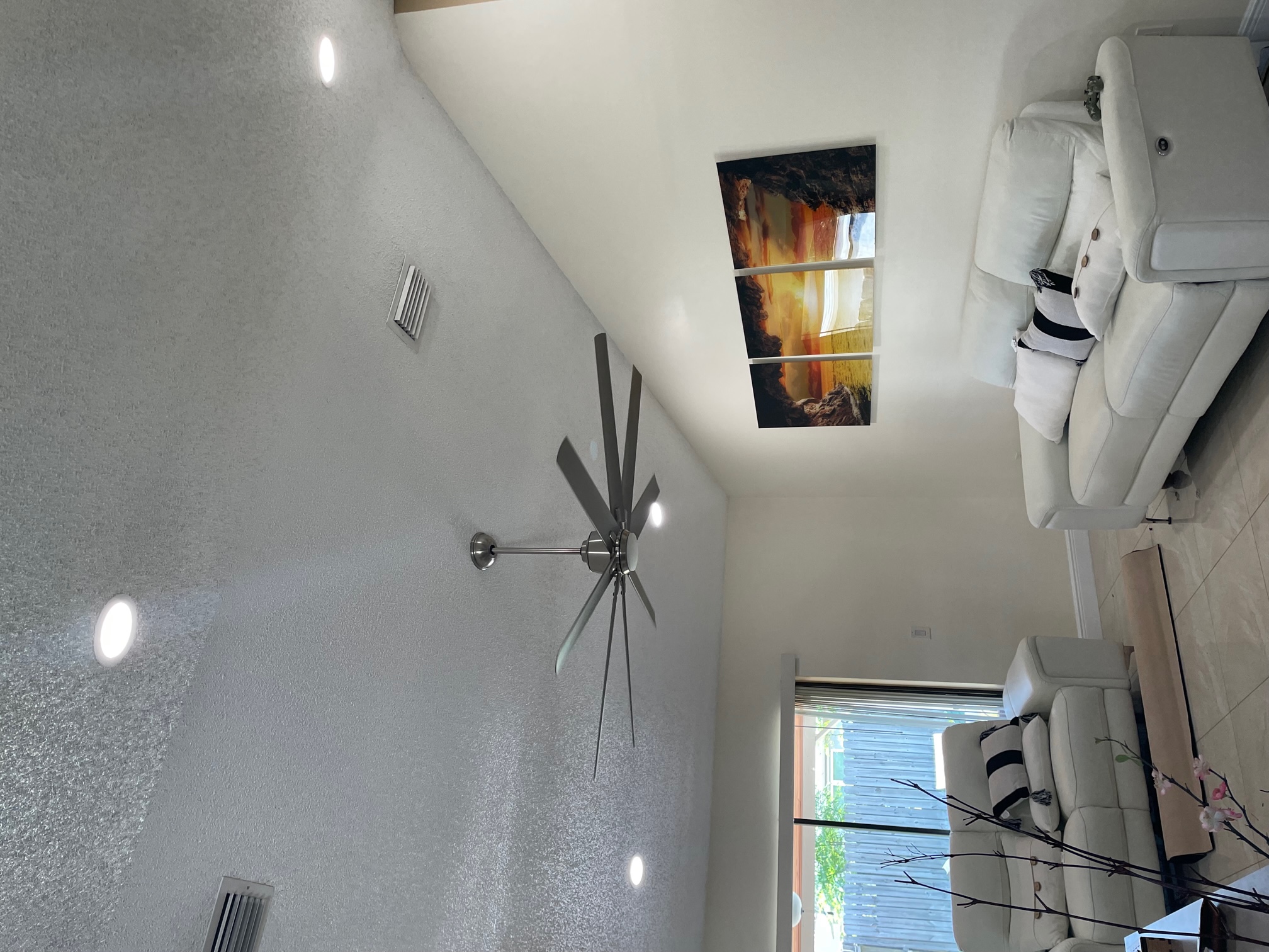 Living room with recessed ceiling lights and ceiling fan